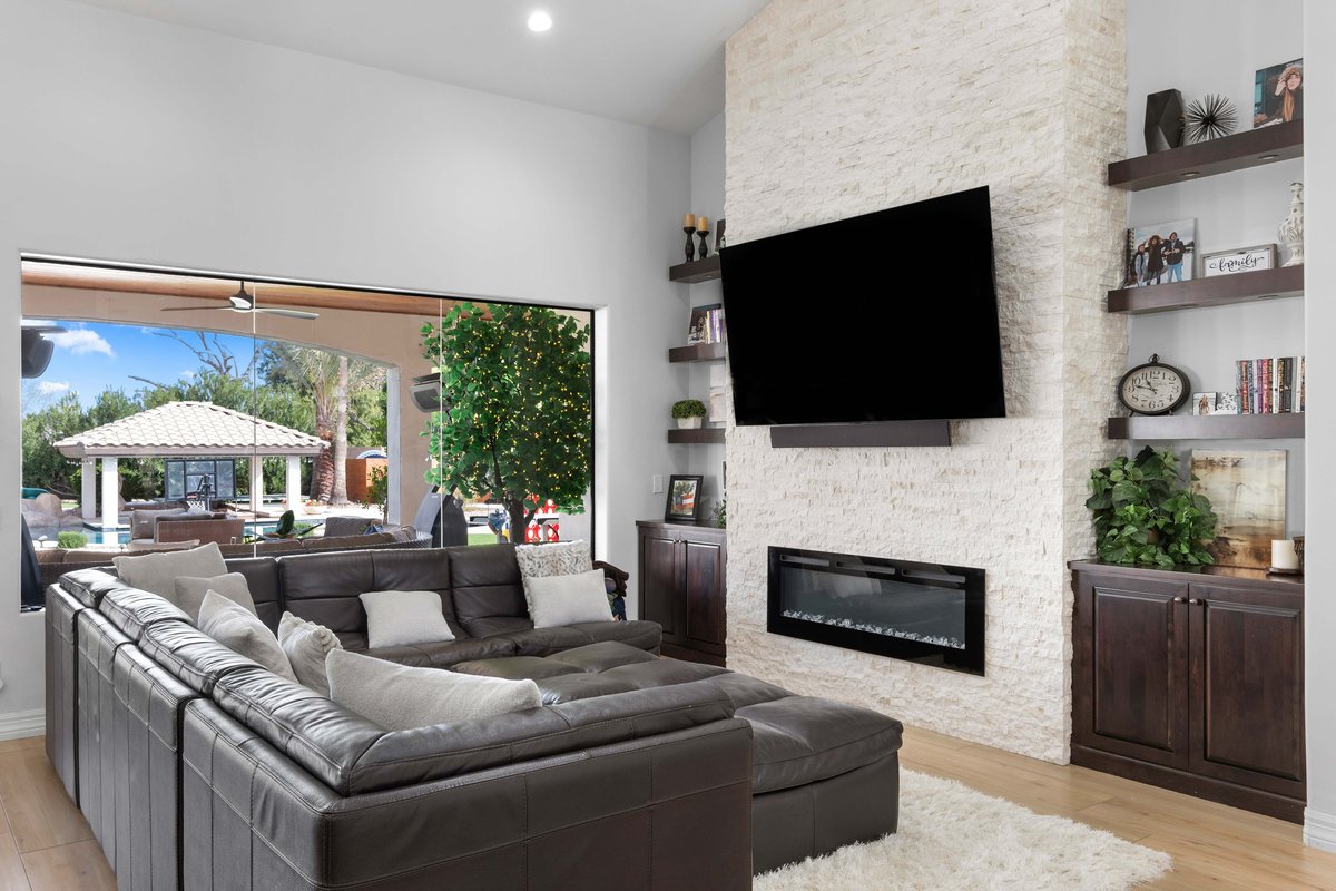 Custom entertainment center with built-in storage and fireplace in Paradise Valley home