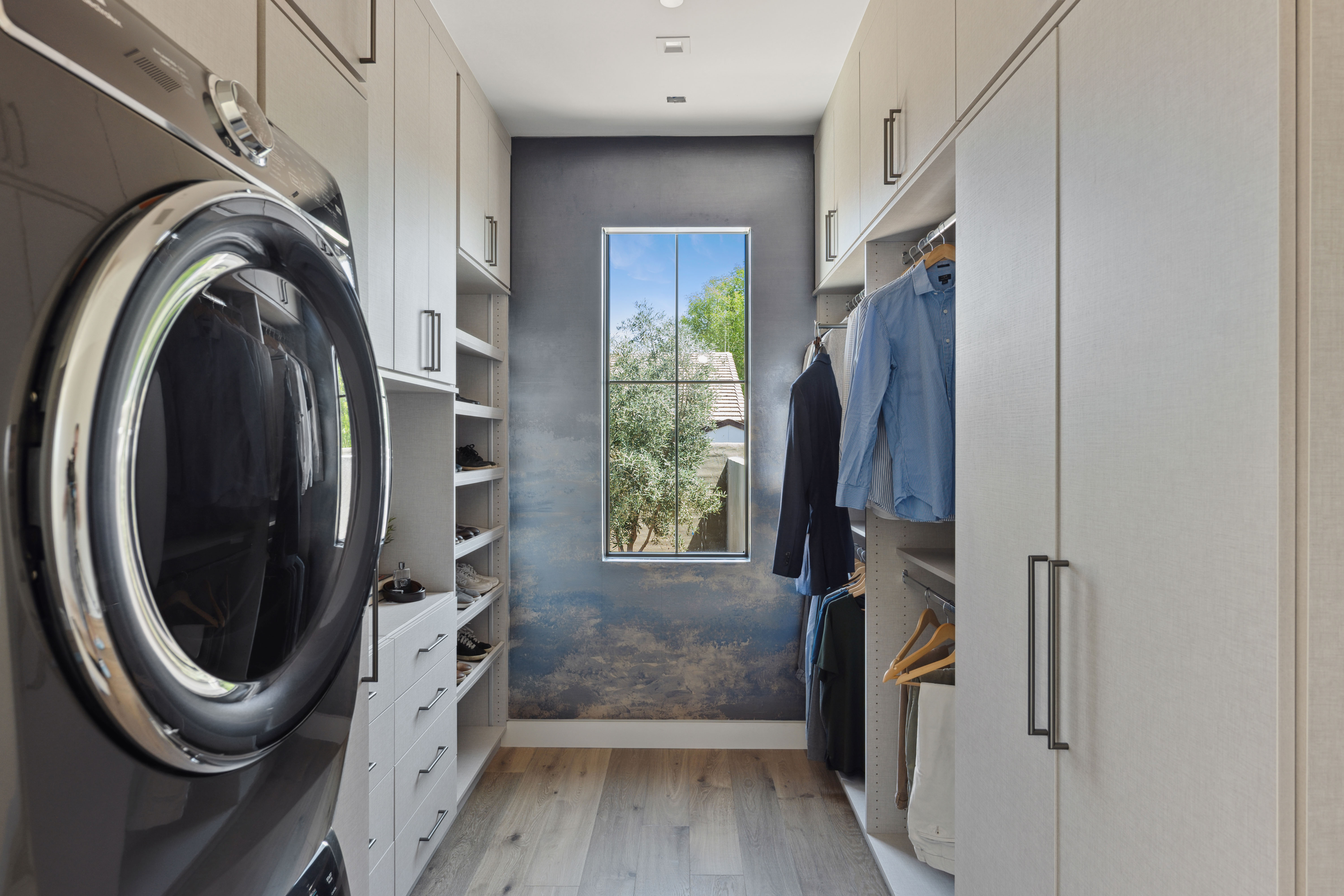 Custom laundry room with built-in cabinets and folding station