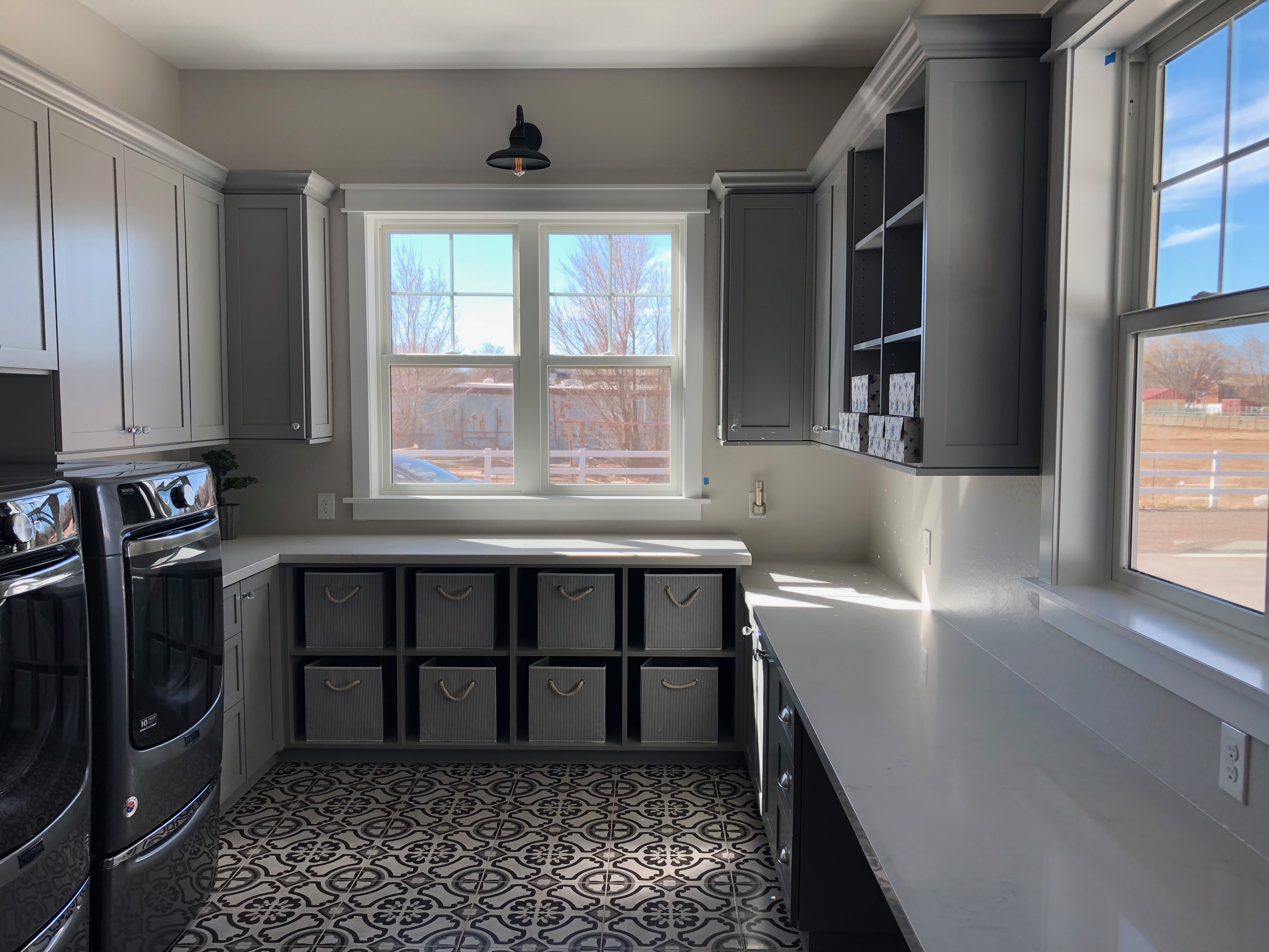 Laundry room with custom storage and hanging rods