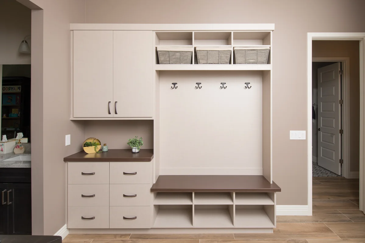 Cream mudroom with bench and basket storage