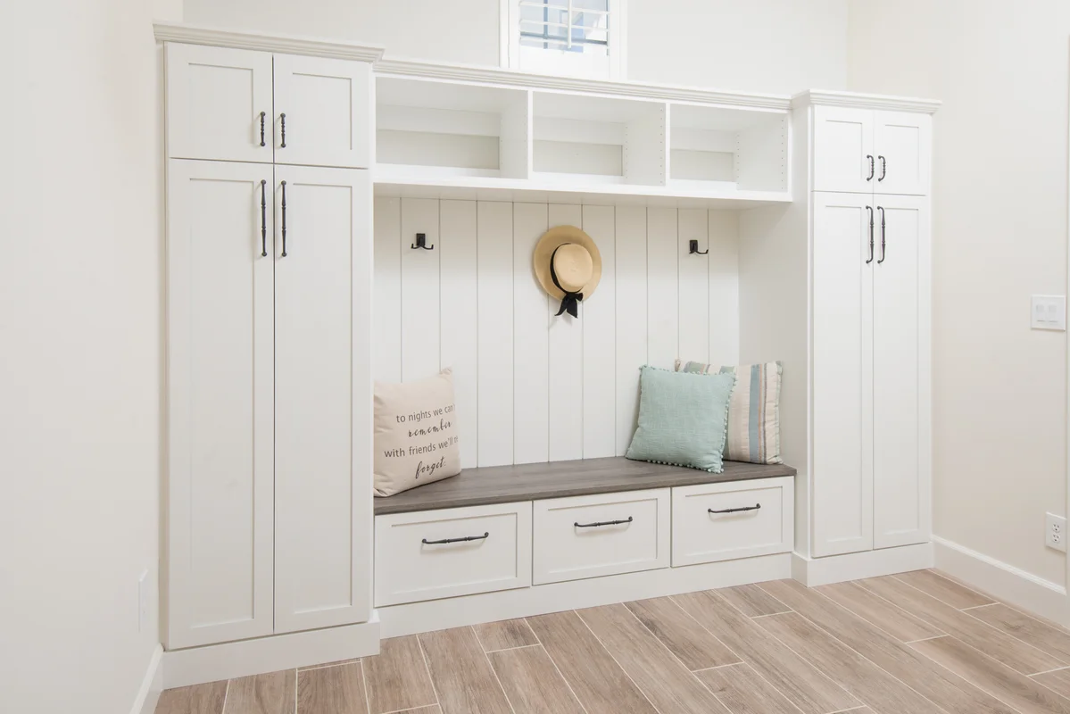 White coastal mudroom with shiplap and bench seating