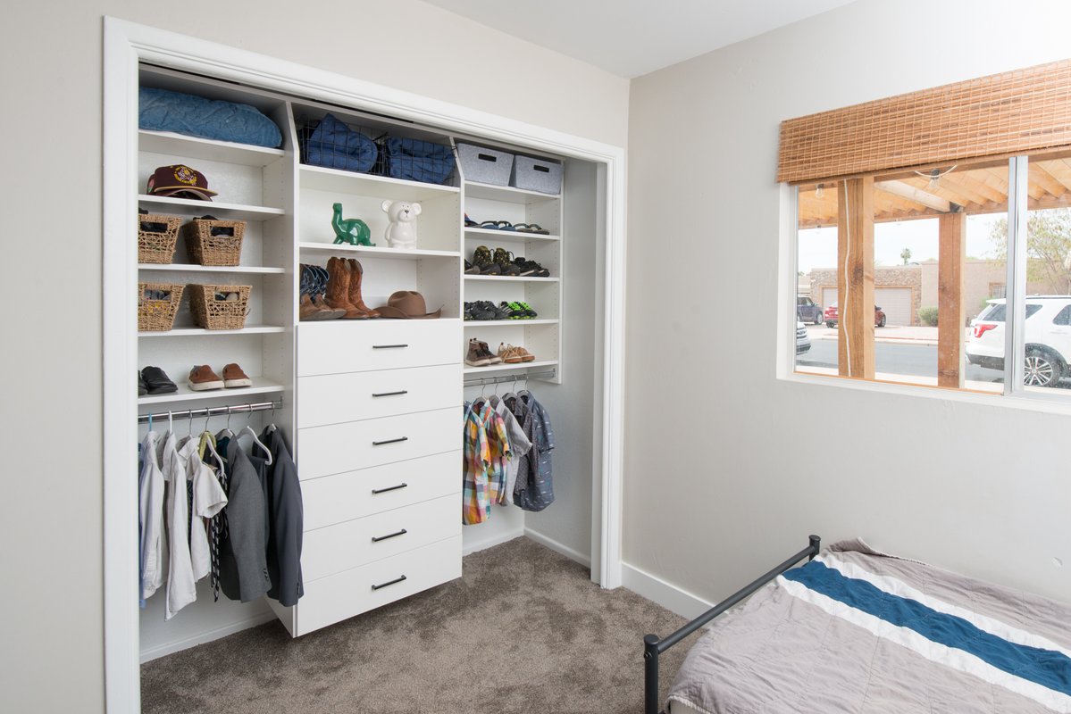 Kids bedroom reach-in closet with custom storage