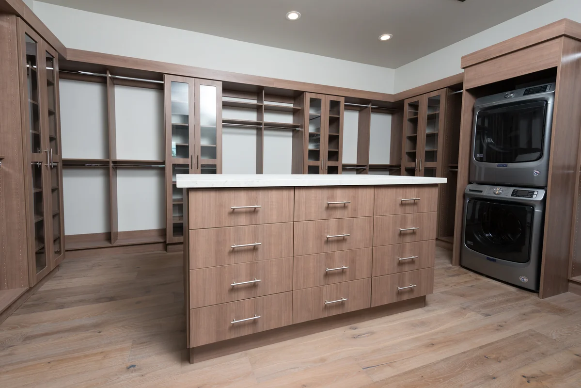 Large walk-in closet with center island and washer dryer