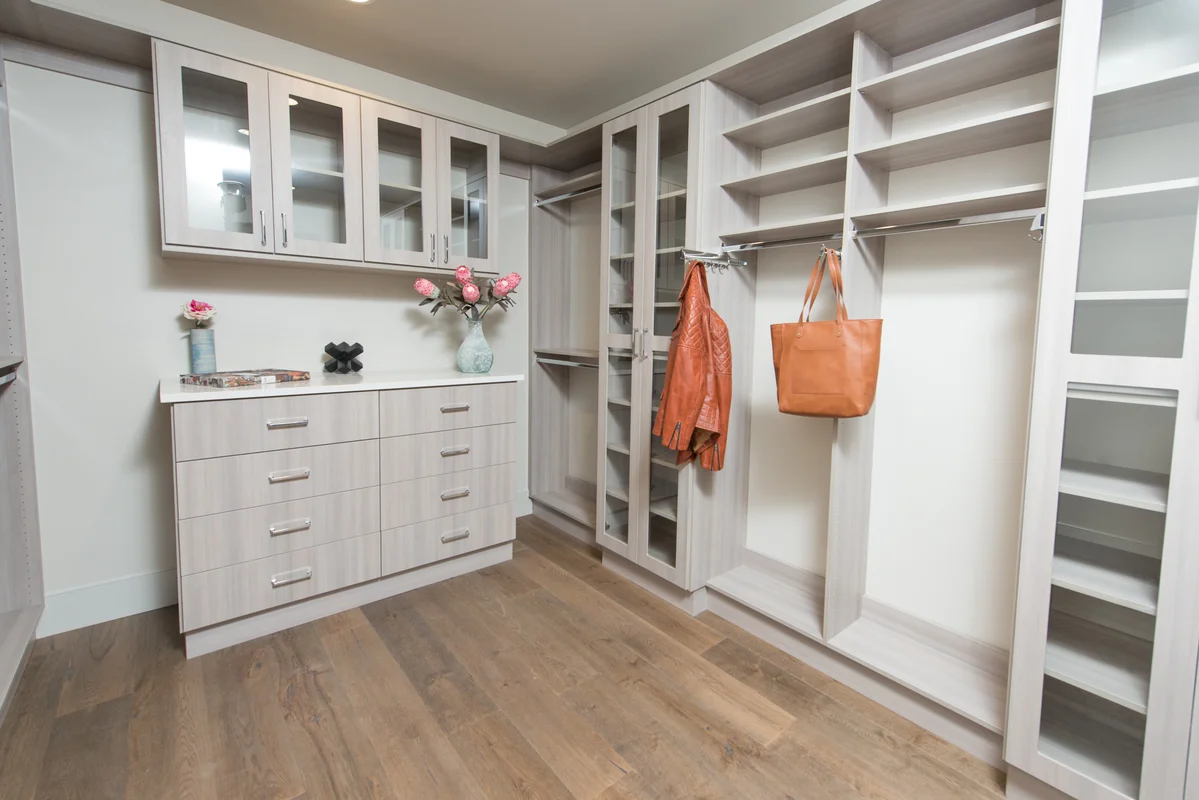 Light gray walk-in closet with decorative accessories