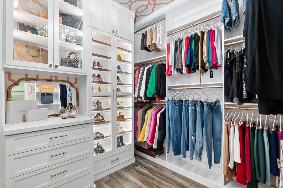 Designer walk-in closet with colorful wardrobe display