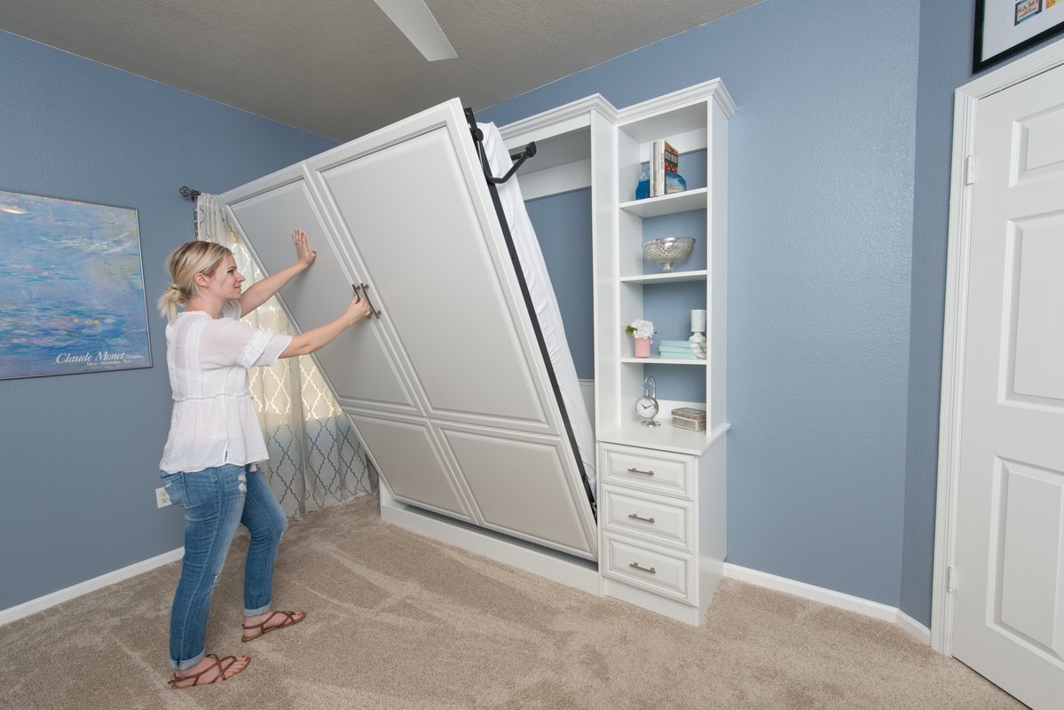 Easy-to-operate wall bed folding into custom cabinetry